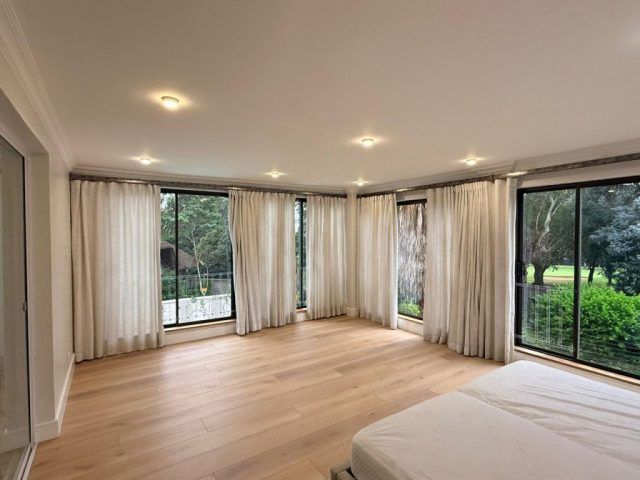 Luxury main bedroom with floor tiles, curtains, bed Aksium Projects