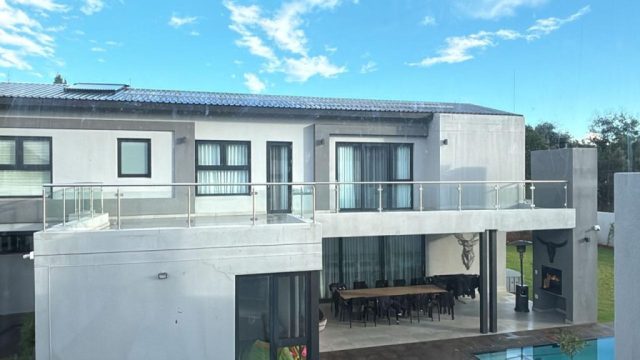 Double storey house with glass railing Aksium Projects