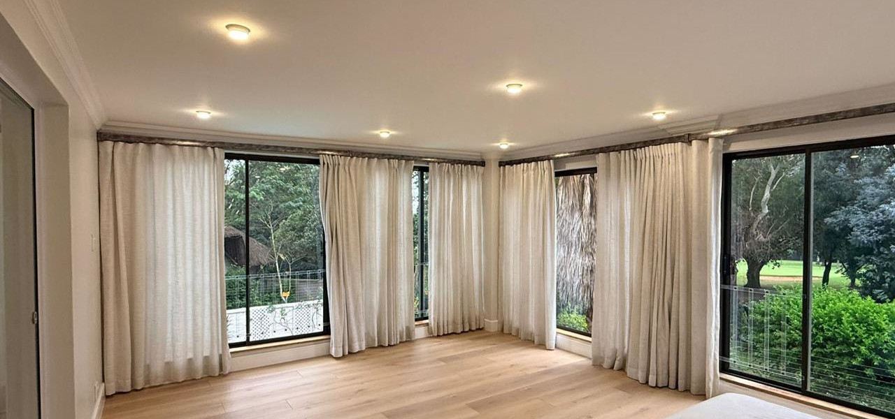 Luxury main bedroom with floor tiles, curtains, bed Aksium Projects