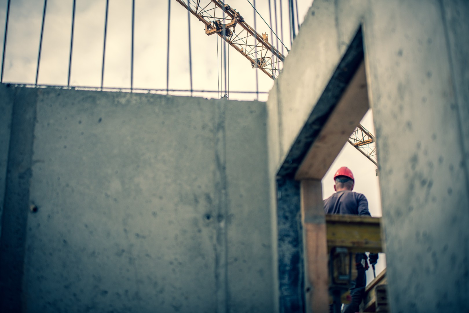 Construction worker on site with concrete structure